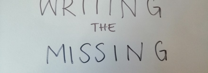 photo description: My grey folder. Written on it in capital letters in black sharpie is WRITING THE MISSING