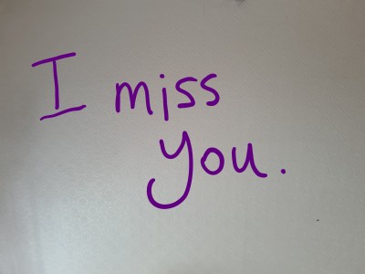 photo description: a still from the film. A white ceiling covered in embossed diamonds. Overlaid in purple handwriting - I miss you.