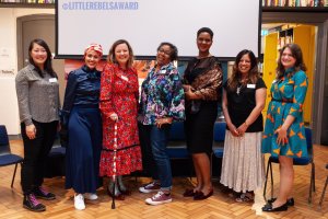photo of seven authors, including me, standing in a library in front of a sign that says Little Rebel Award